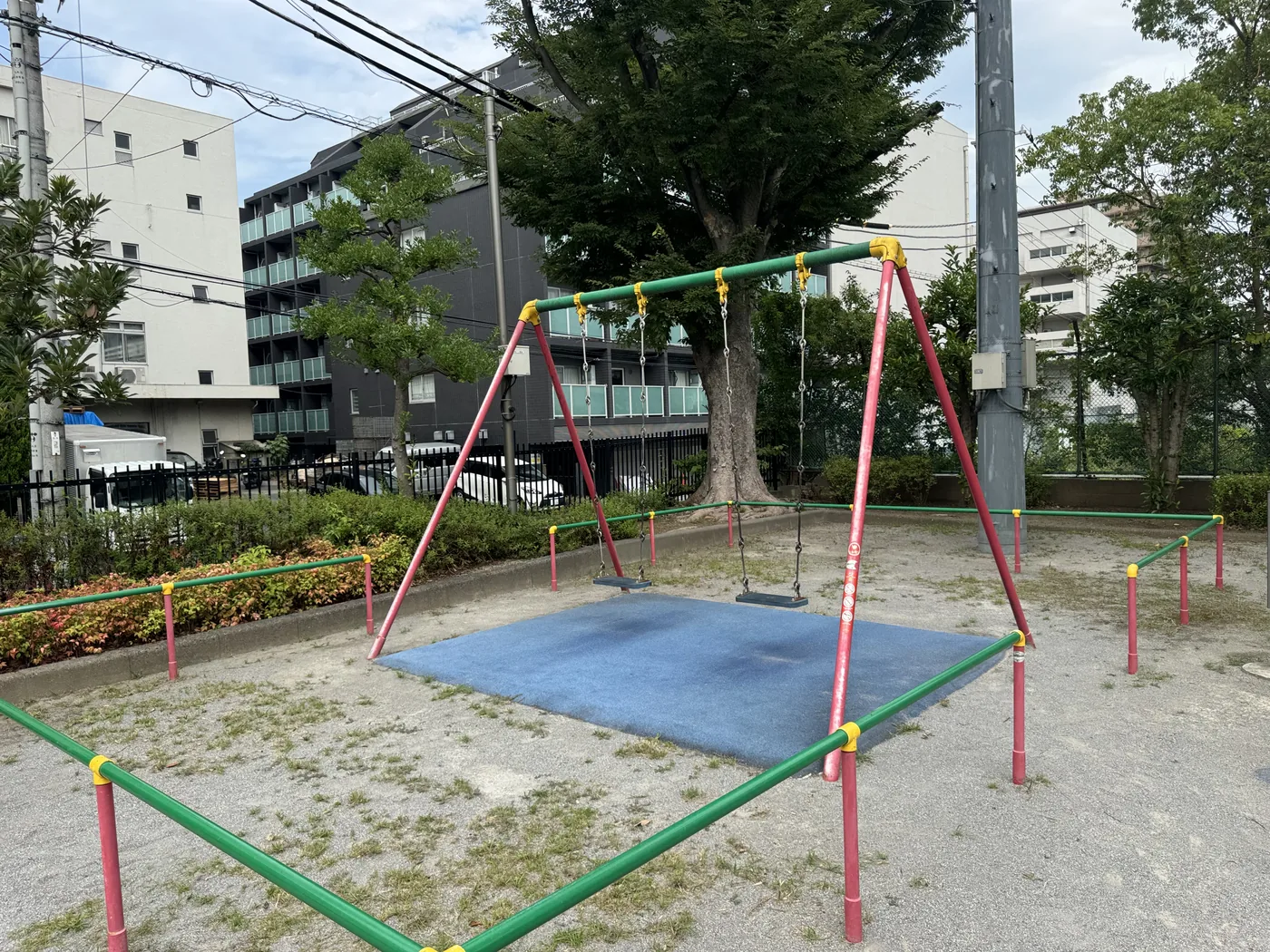 赤い脚のブランコと青い安全マット